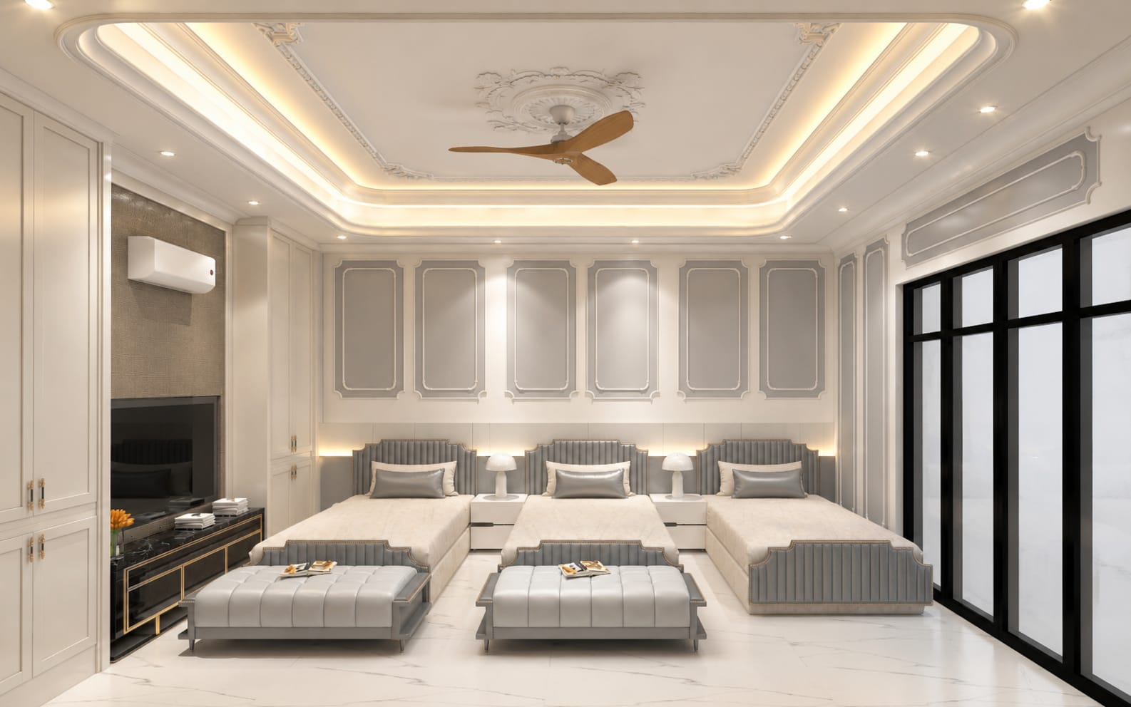 Interior of a light bedroom suite with panelled walls, cove lighting and three upholstered beds